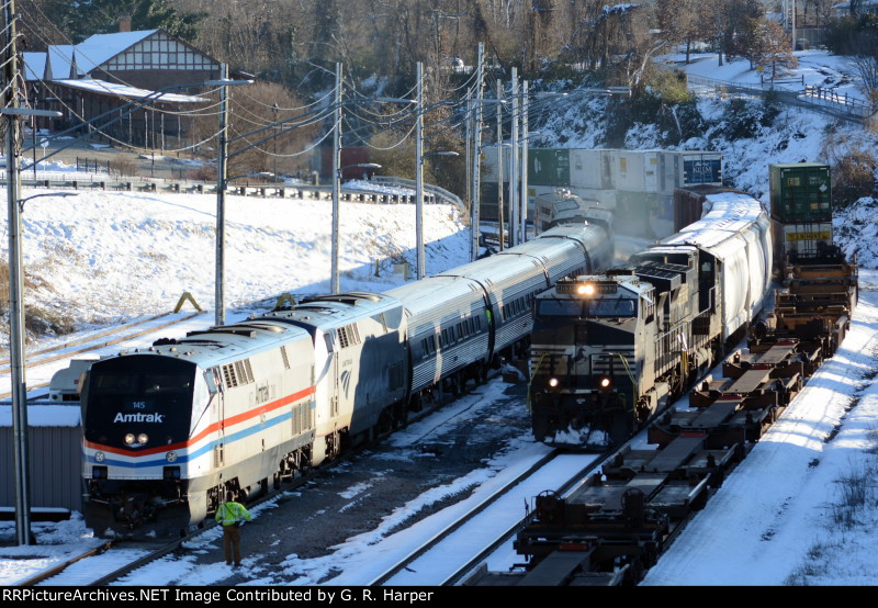 The NS yard job passes parked Amtrak train #20(2) on its way to work the First Brands plant in Amherst, VA.